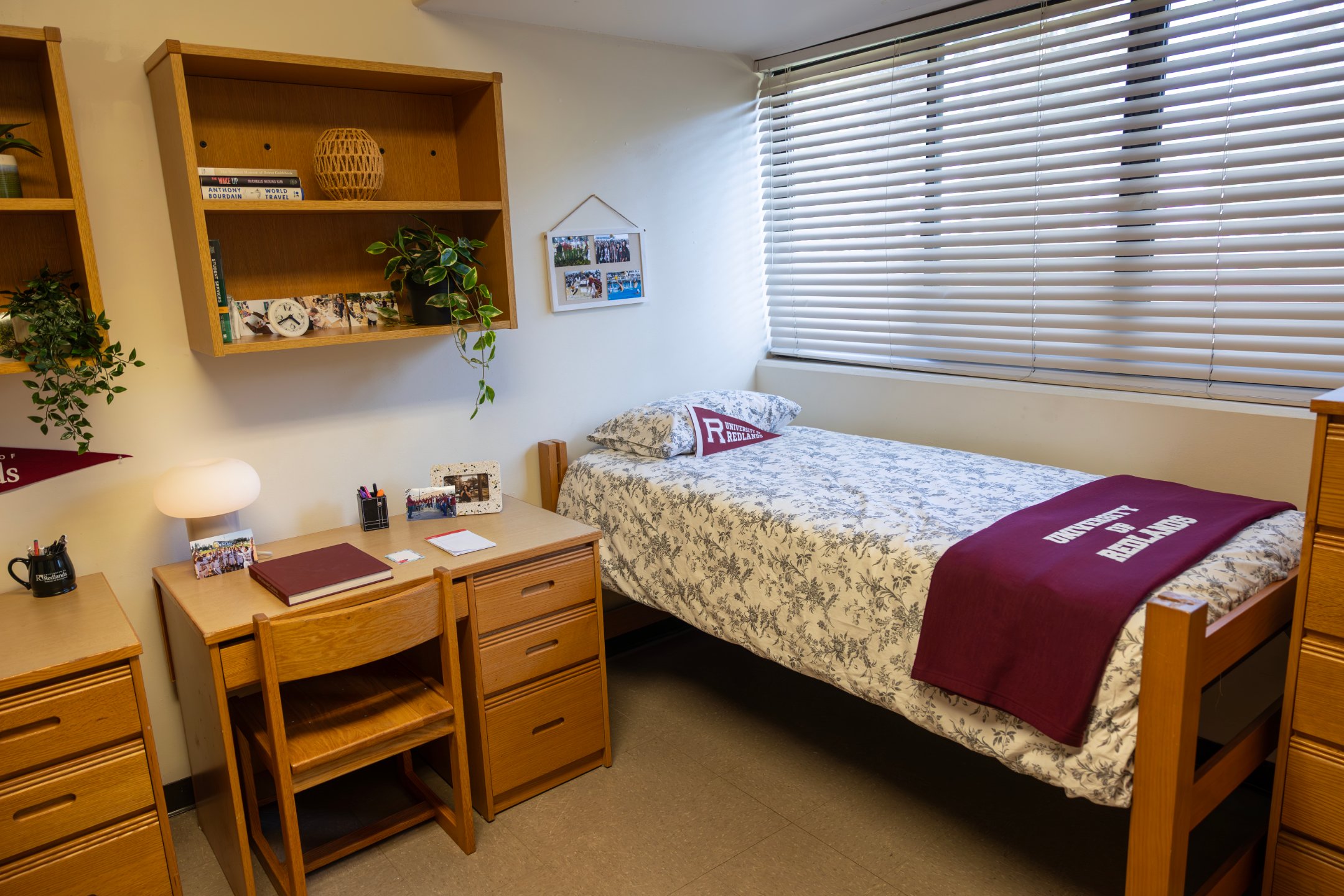 a bedroom with a bed and desk and a window