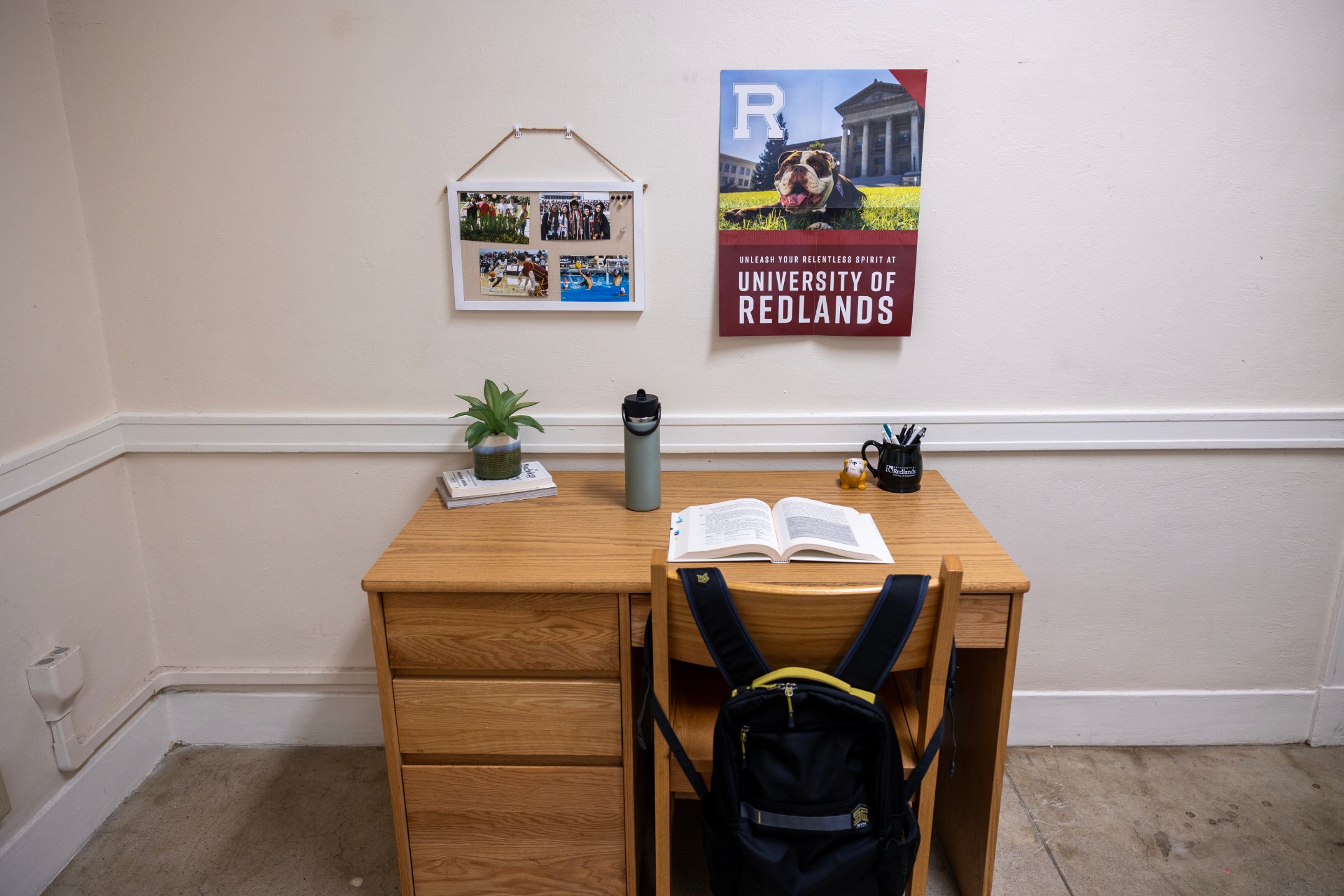 a desk with a backpack and a book on it