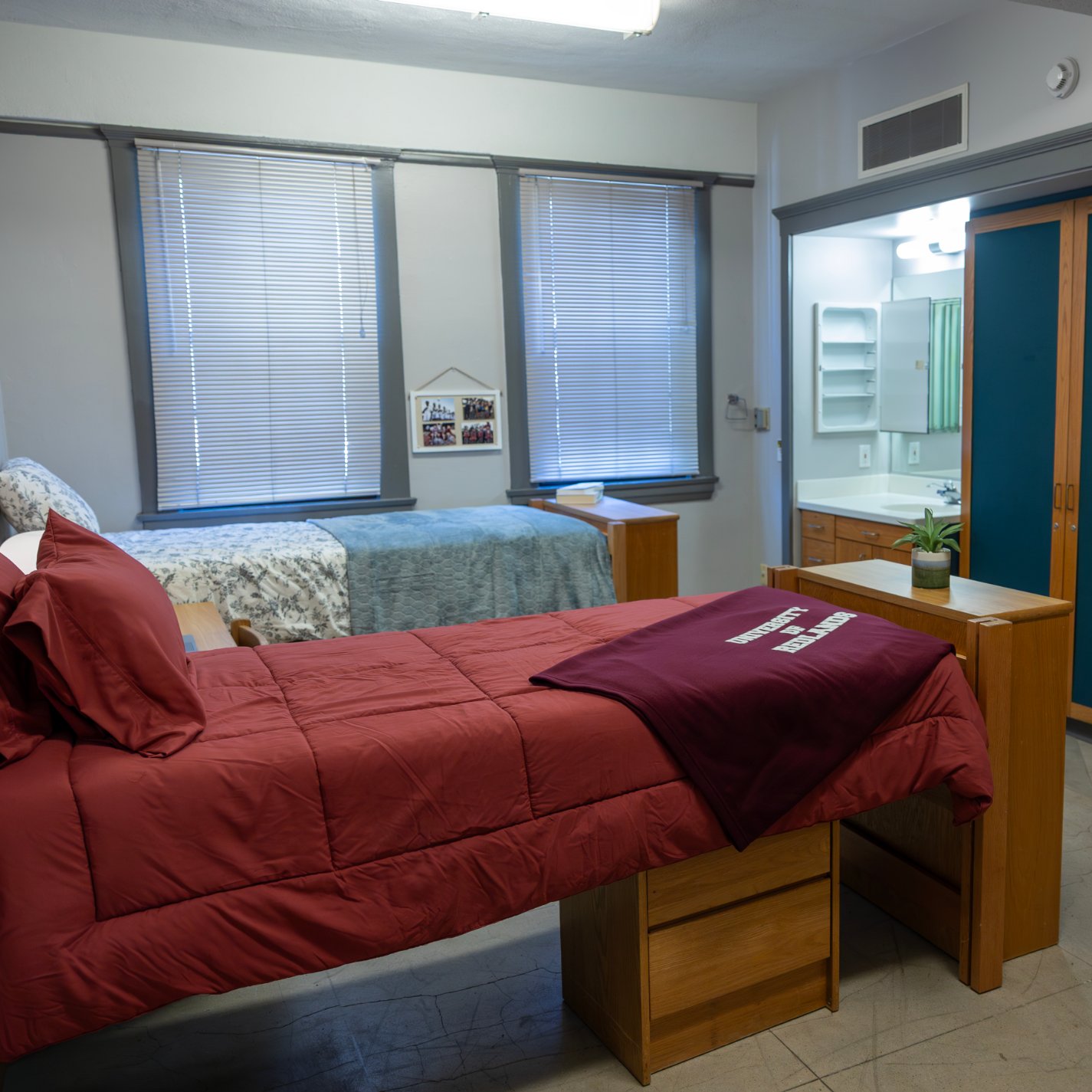 a room with two beds and a mirror