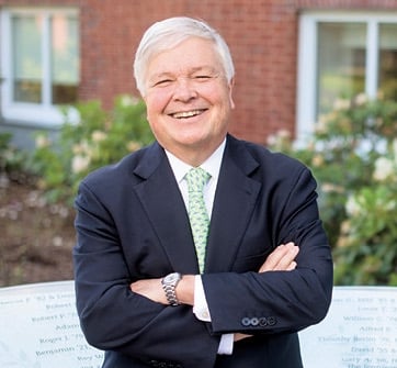 a man in a suit with his arms crossed