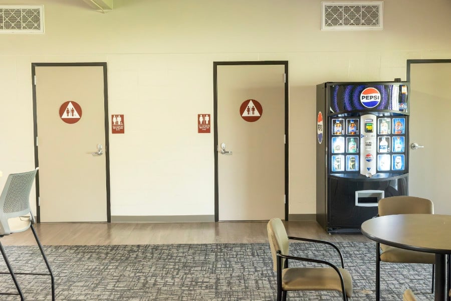 a room with a vending machine and a chair