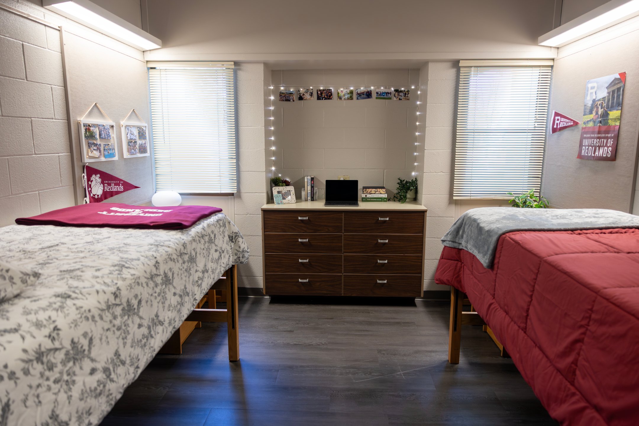 a room with two beds and a desk