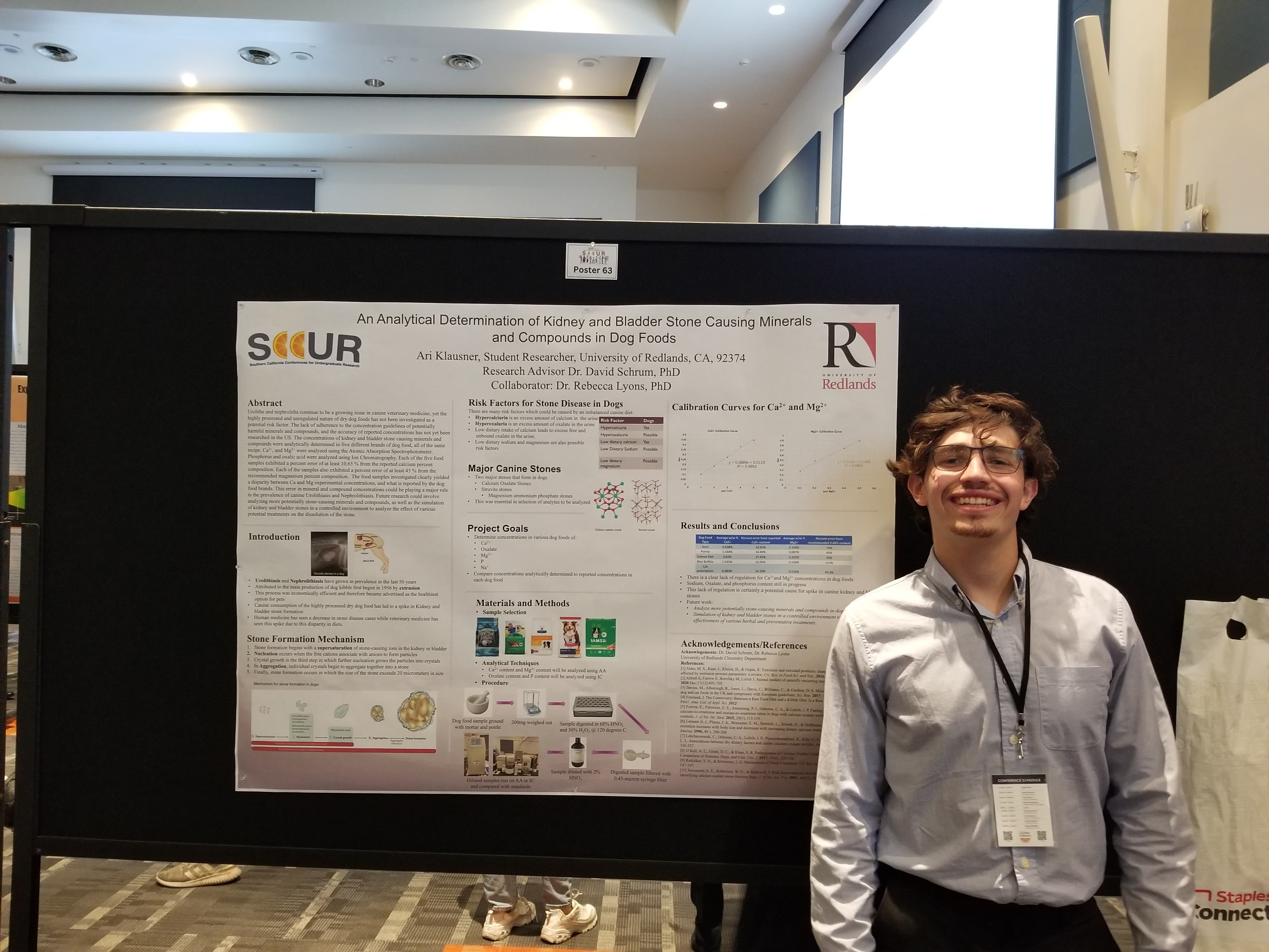 a man standing next to a poster