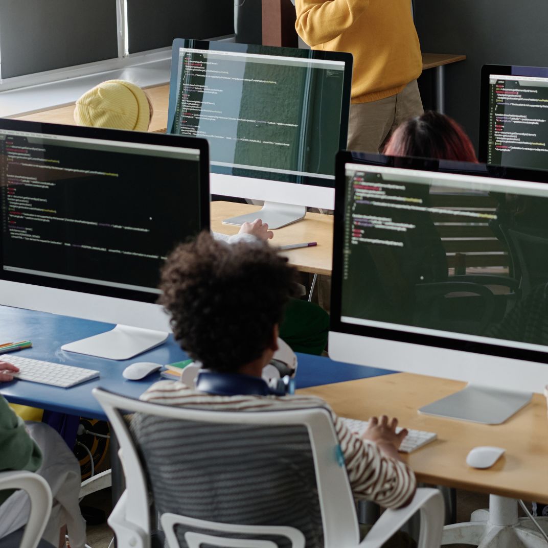 a group of people in a room with computers