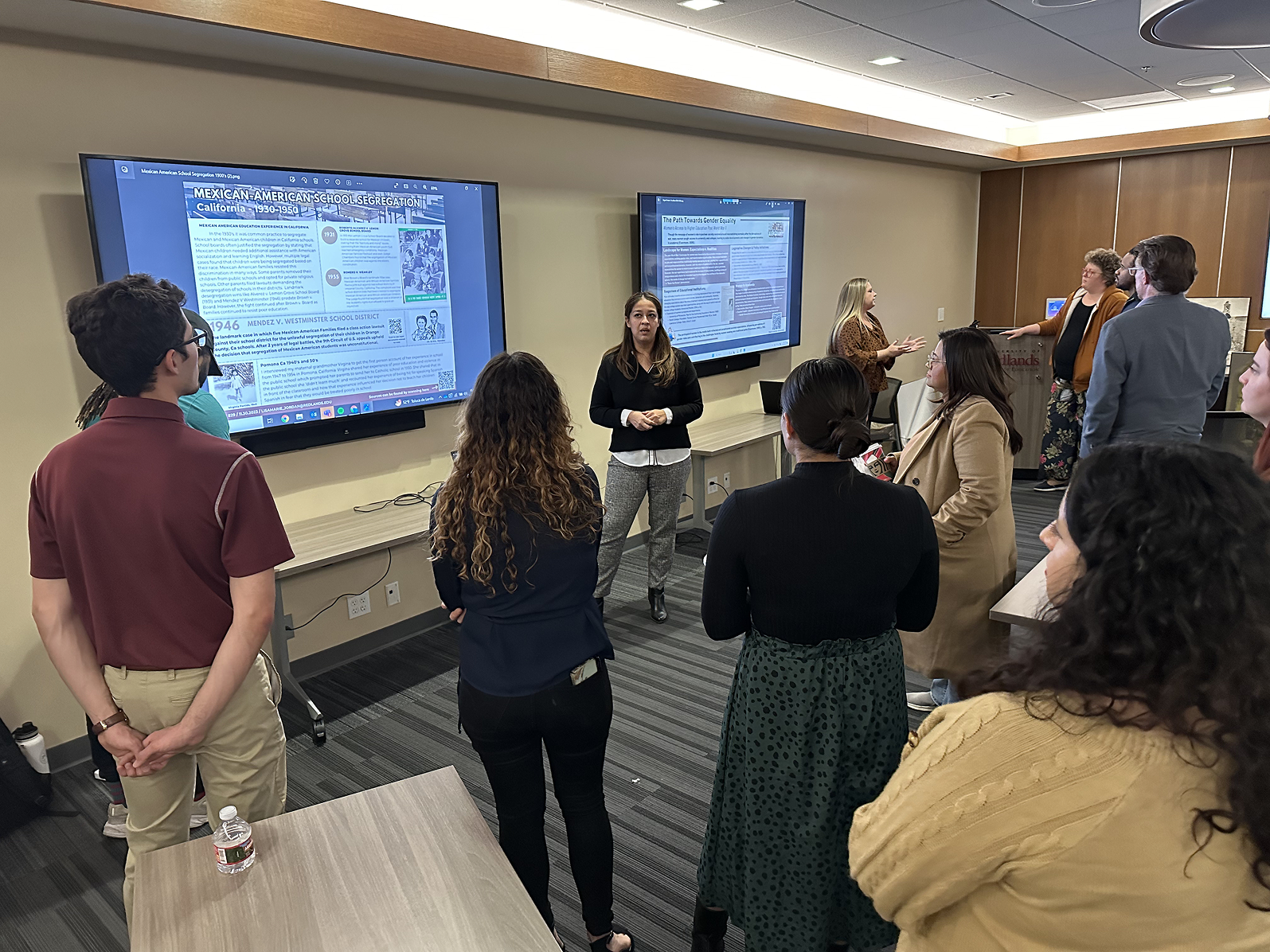 a group of people standing in front of a screen